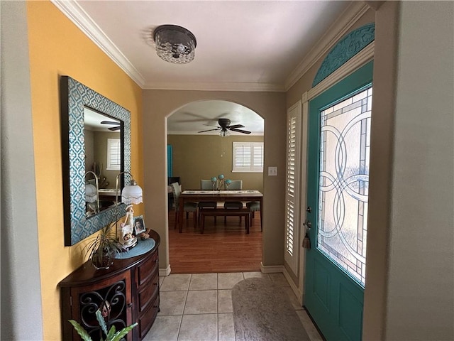 1645 W Manor Dr W, Corpus Christi, TX 78412 - entryway with arched walkways, crown molding, healthy amount of natural light, a ceiling fan, and light tile patterned floors