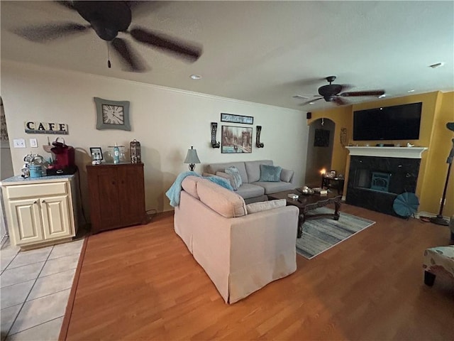 1645 W Manor Dr W, Corpus Christi, TX 78412 - living area with a ceiling fan, light wood finished floors, and a glass covered fireplace