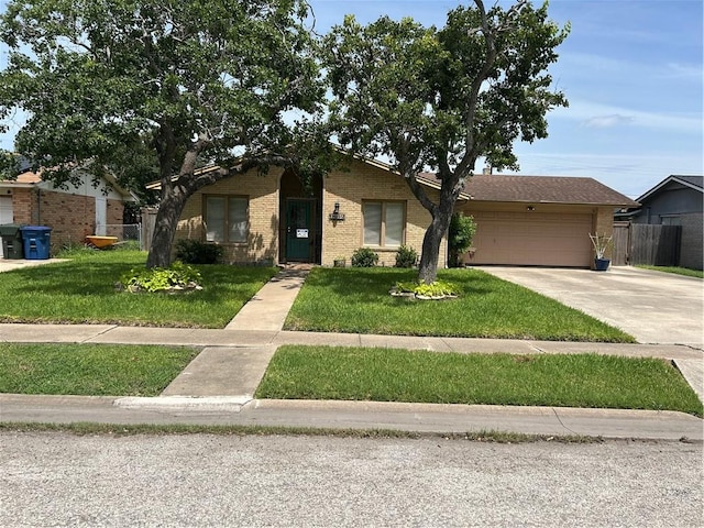 1645 W Manor Dr W, Corpus Christi, TX 78412 - view of front of house featuring brick siding, a garage, and concrete driveway