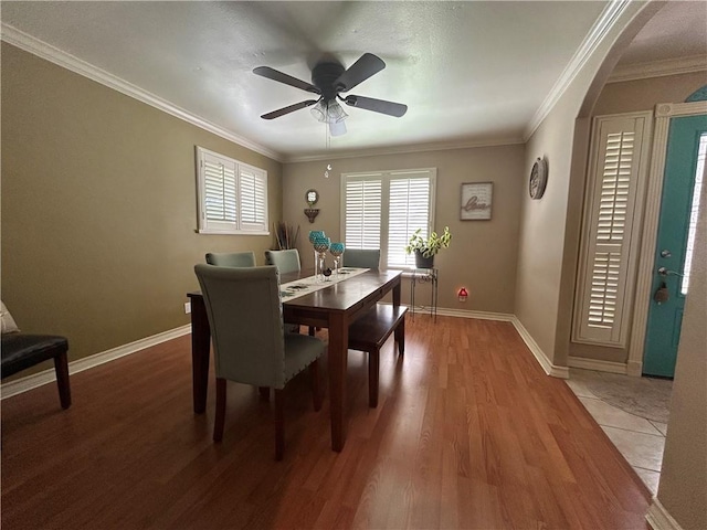 1645 W Manor Dr W, Corpus Christi, TX 78412 - dining space with wood finished floors, arched walkways, ornamental molding, and ceiling fan