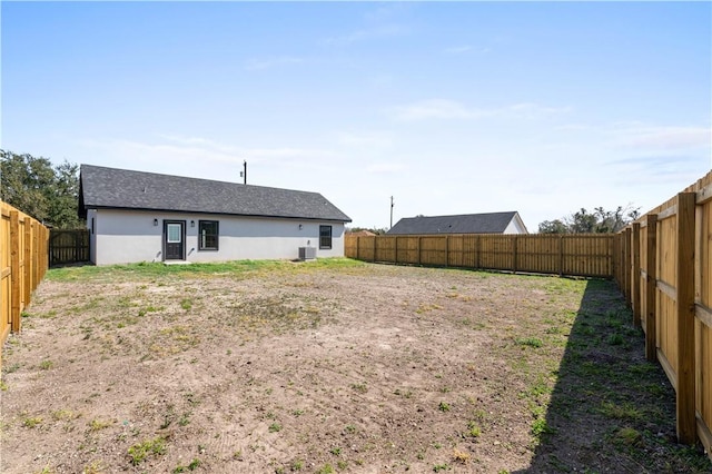 view of yard featuring central AC and a fenced backyard