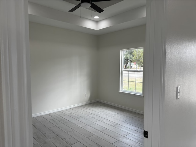 empty room featuring light wood-type flooring and ceiling fan