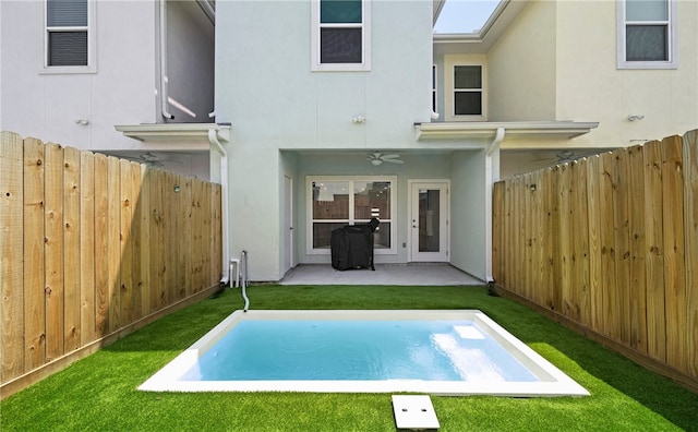 back of property featuring a yard, a patio, and ceiling fan