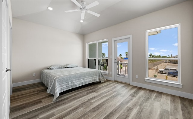 bedroom featuring lofted ceiling, hardwood / wood-style floors, access to exterior, and ceiling fan