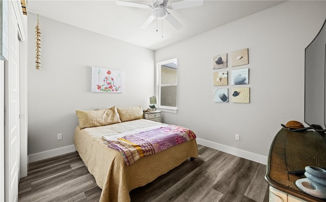 bedroom with dark hardwood / wood-style floors and ceiling fan