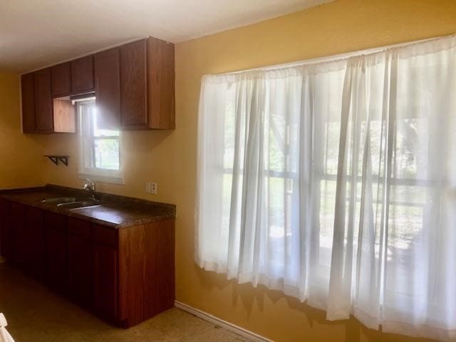 502 S Stephenson St, Beeville, TX 78102 - kitchen featuring dark countertops and brown cabinets