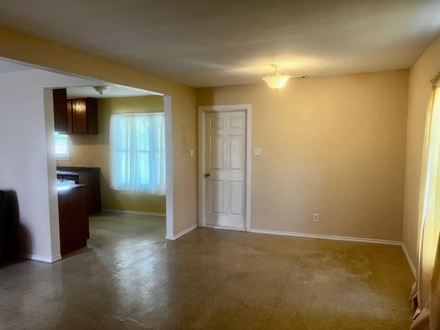 502 S Stephenson St, Beeville, TX 78102 - unfurnished dining area featuring baseboards