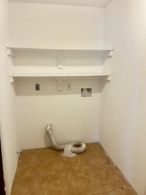 502 S Stephenson St, Beeville, TX 78102 - laundry area with hookup for an electric dryer, hookup for a washing machine, and tile patterned floors
