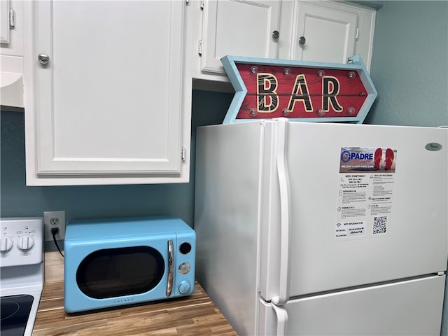 laundry room with hardwood / wood-style floors