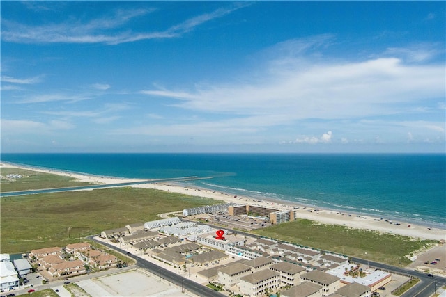 drone / aerial view featuring a beach view and a water view