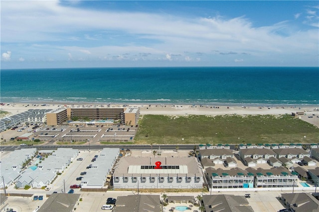 drone / aerial view featuring a water view and a beach view