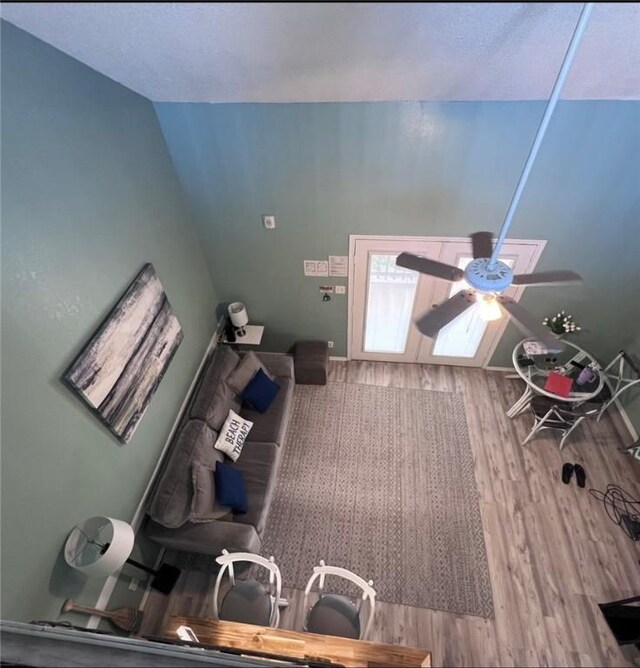 bedroom featuring ceiling fan, a textured ceiling, a closet, and light wood-type flooring