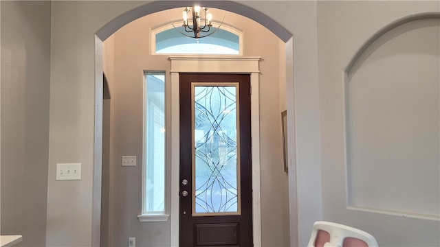 foyer entrance featuring a notable chandelier