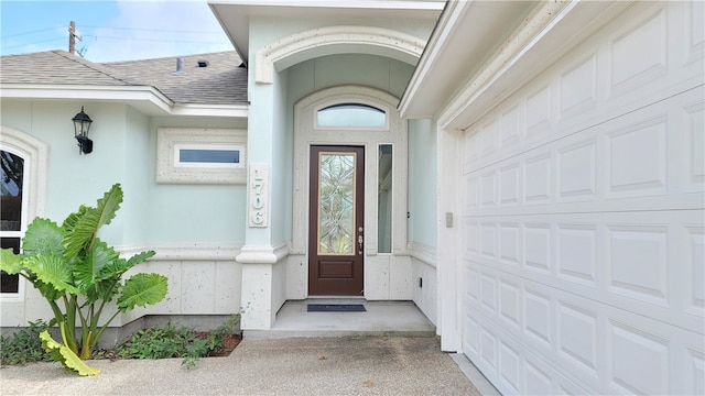 view of exterior entry with a garage