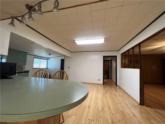 unfurnished dining area with wood walls and light hardwood / wood-style floors