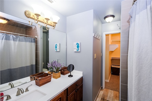 bathroom featuring a shower with shower curtain, wood-type flooring, and vanity