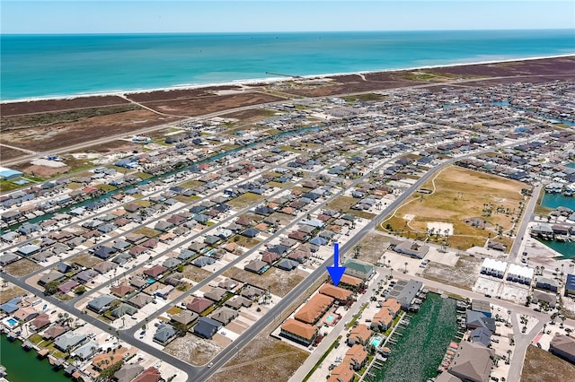 bird's eye view with a water view and a beach view