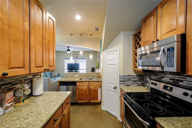 kitchen with stainless steel appliances, ceiling fan, decorative light fixtures, and decorative backsplash