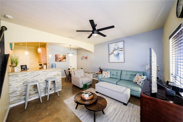 living room with concrete flooring and ceiling fan