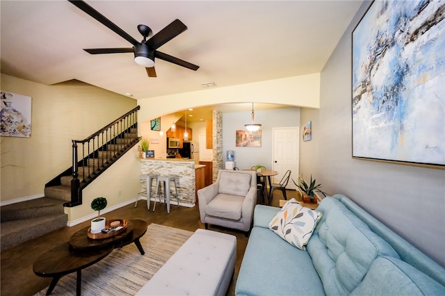 carpeted living room with ceiling fan