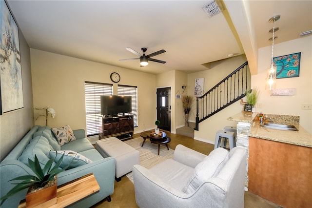 living room featuring sink and ceiling fan