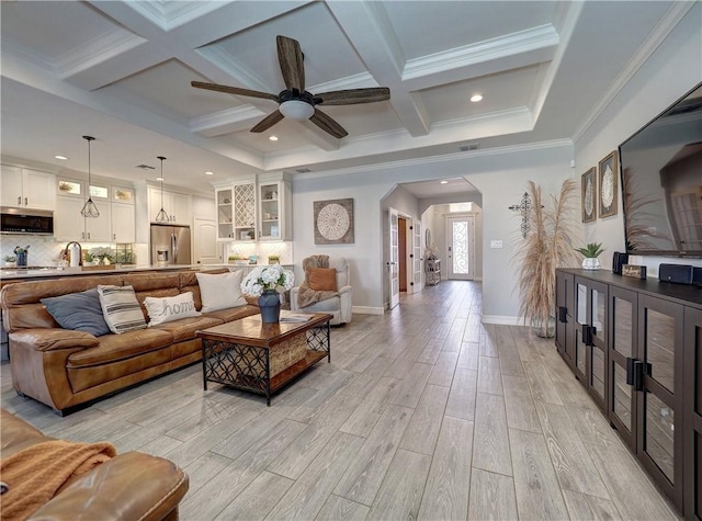 living room with arched walkways, coffered ceiling, baseboards, light wood finished floors, and beamed ceiling