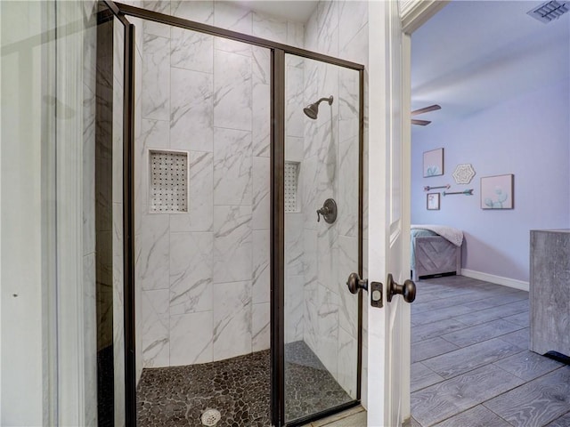 ensuite bathroom with a marble finish shower, visible vents, wood finished floors, and ensuite bathroom