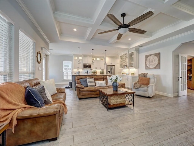 living area featuring arched walkways, coffered ceiling, baseboards, and wood tiled floor