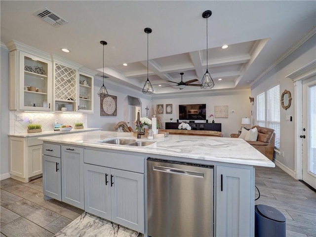 kitchen featuring visible vents, stainless steel dishwasher, wood tiled floor, open floor plan, and a sink