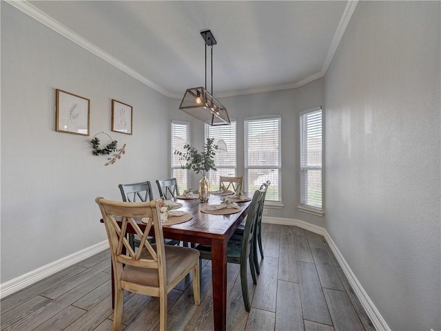 dining area with ornamental molding, wood finished floors, and baseboards