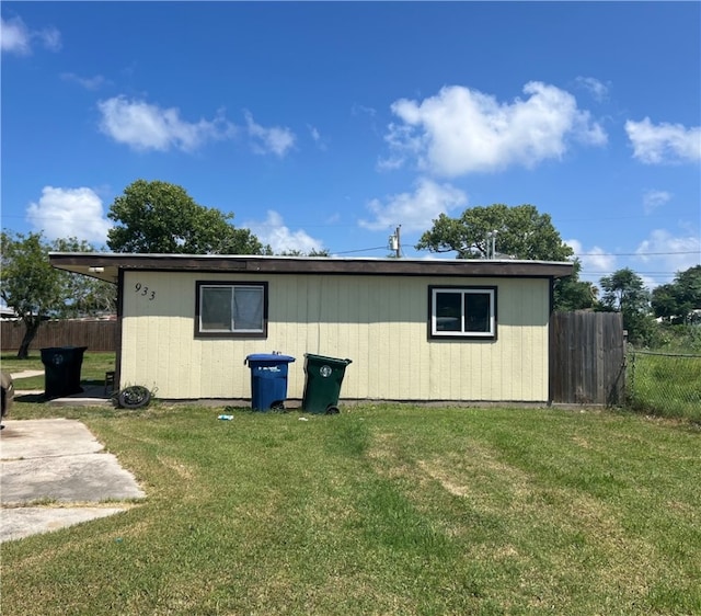 view of side of home with a yard