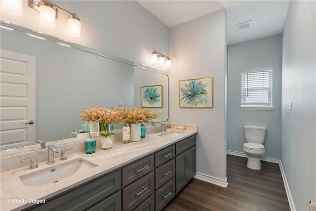 113 Knickerbocker St, Corpus Christi, TX 78418 - full bathroom with double vanity, wood finished floors, toilet, and baseboards
