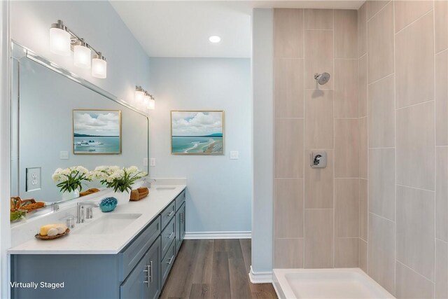 113 Knickerbocker St, Corpus Christi, TX 78418 - bathroom featuring double vanity, a tile shower, wood finished floors, baseboards, and recessed lighting