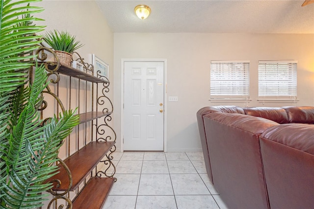 tiled foyer entrance with a textured ceiling