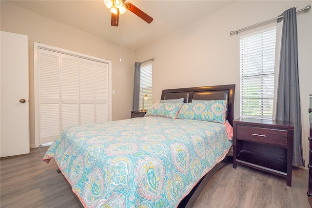 bedroom featuring a closet, wood-type flooring, and ceiling fan