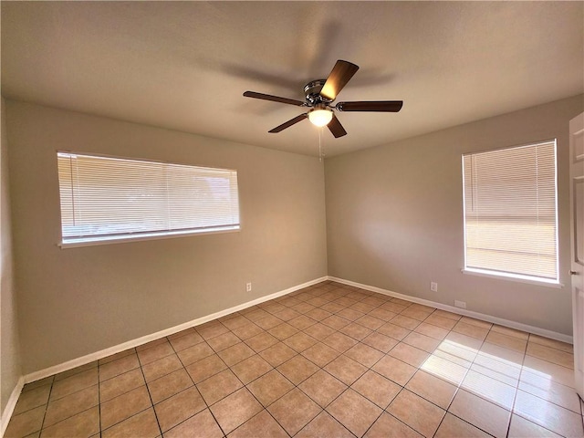 unfurnished room with ceiling fan, light tile patterned floors, and a healthy amount of sunlight