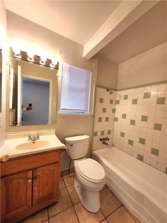 full bathroom with tiled shower / bath, tile patterned floors, toilet, and vanity