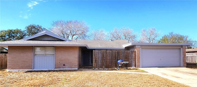 ranch-style house with a garage and a front yard