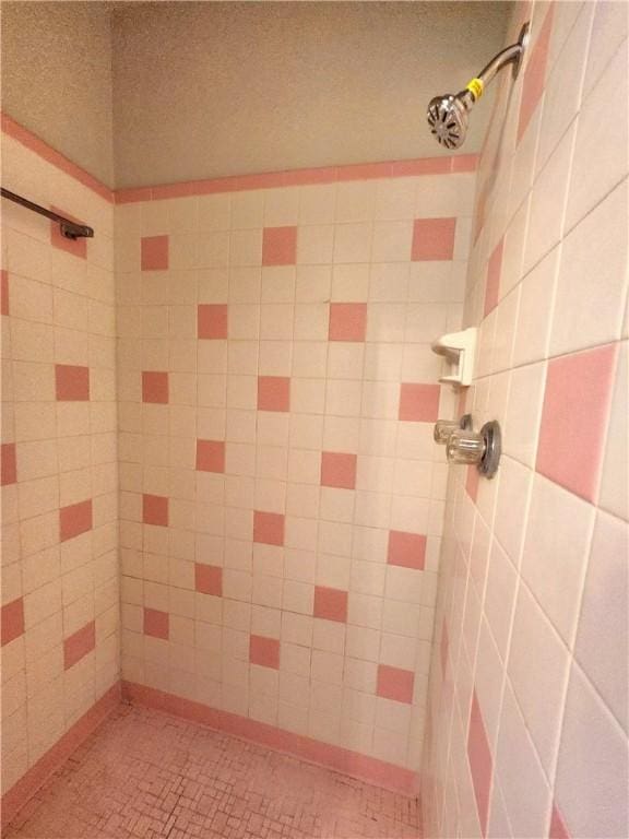 bathroom with a tile shower