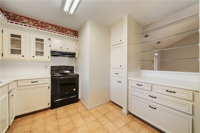 13341 Scenic Cir, Corpus Christi, TX 78410 - kitchen featuring electric range, under cabinet range hood, light countertops, glass insert cabinets, and light floors