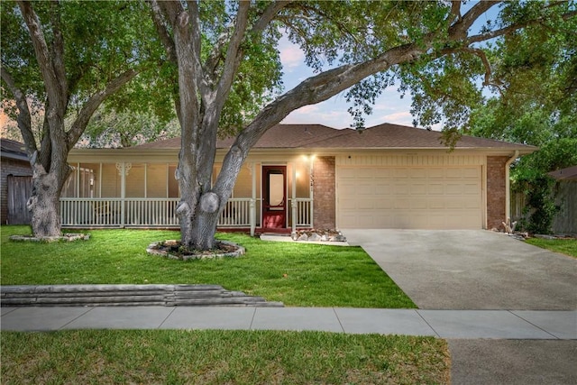 13341 Scenic Cir, Corpus Christi, TX 78410 - ranch-style home with a garage, brick siding, concrete driveway, a front yard, and covered porch
