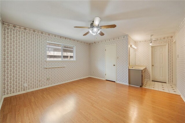 13341 Scenic Cir, Corpus Christi, TX 78410 - unfurnished bedroom featuring light wood-style floors, wallpapered walls, and ceiling fan