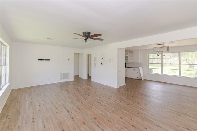 704 E Henderson St, Bishop, TX 78343 - unfurnished living room featuring light wood-style floors and a ceiling fan