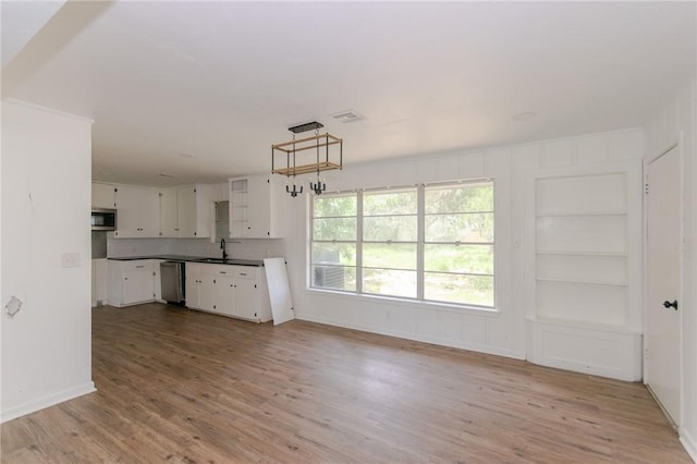 704 E Henderson St, Bishop, TX 78343 - unfurnished living room featuring light wood-style floors and built in features