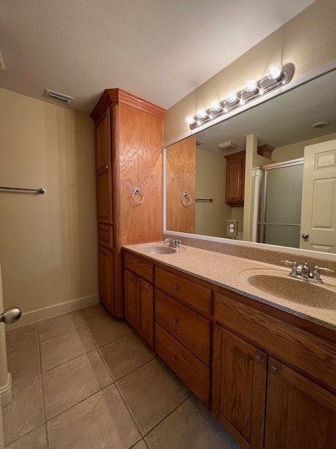 bathroom featuring walk in shower, vanity, and tile patterned floors