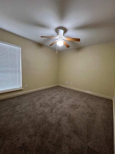 empty room with carpet flooring and ceiling fan