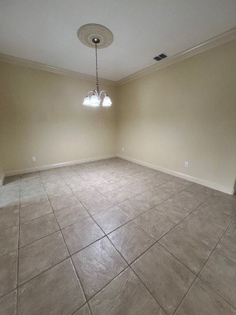 spare room featuring a notable chandelier and crown molding