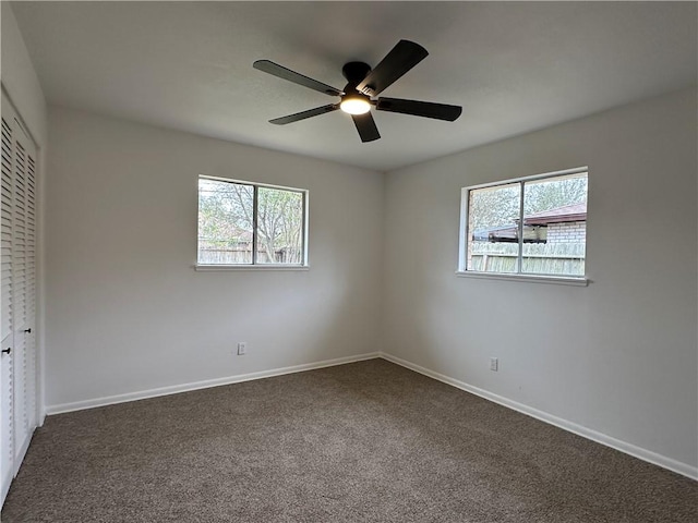 6118 Locke, Corpus Christi, TX 78415 - unfurnished bedroom featuring multiple windows, a closet, dark carpet, and ceiling fan