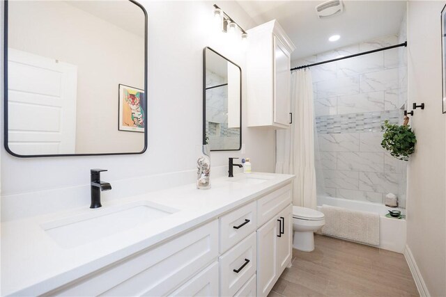 4101 Karo Dr, Corpus Christi, TX 78414 - full bath with double vanity, shower / bath combo, and wood finished floors