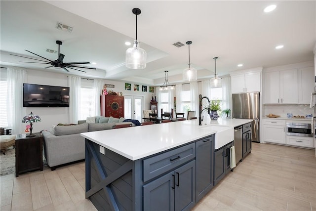 4101 Karo Dr, Corpus Christi, TX 78414 - kitchen with appliances with stainless steel finishes, white cabinetry, light countertops, light wood-style floors, and recessed lighting